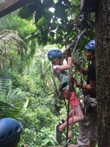 Fay, hoisting herself up to zipline