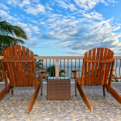 Two Adirondack chairs on Belize rooftop