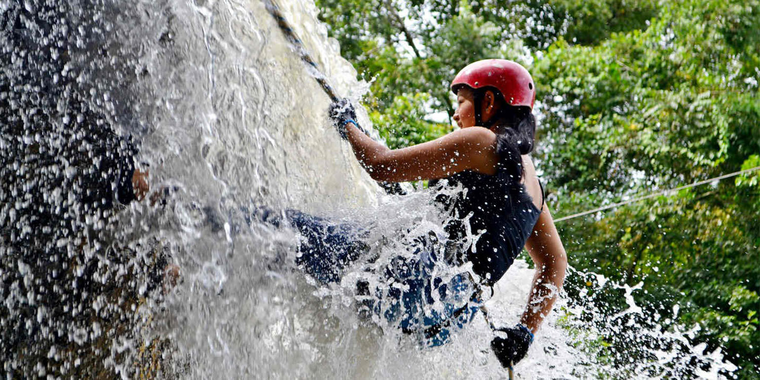 Belize waterfall rappelling