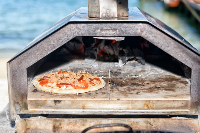 Wood-fired pizza on beach