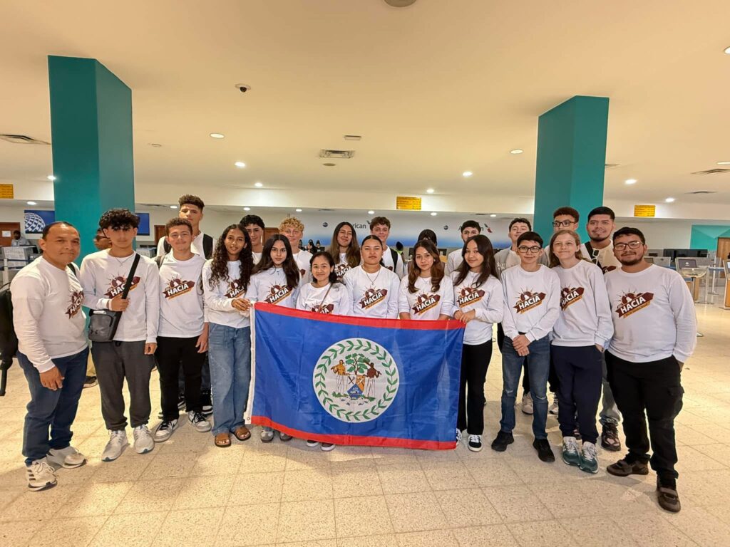 Entire team in airport with flag