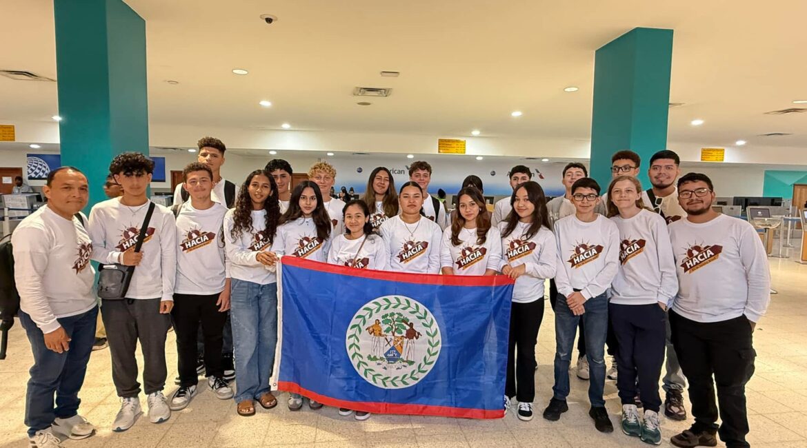 Entire team in airport with flag