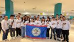 Entire team in airport with flag